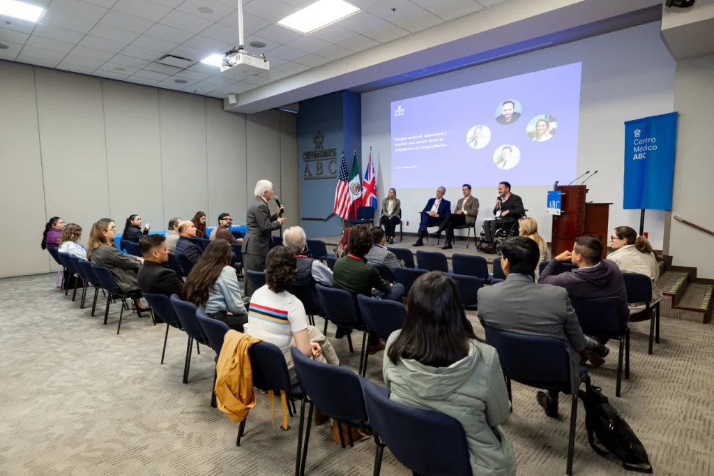 Participante del congreso de psiquiatría de enlace 2025 realizando una pregunta a ponentes durante el evento.