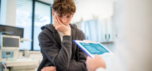 Emotional health care for adolescents Adolescent showing signs of concern or anxiety during a medical consultation
